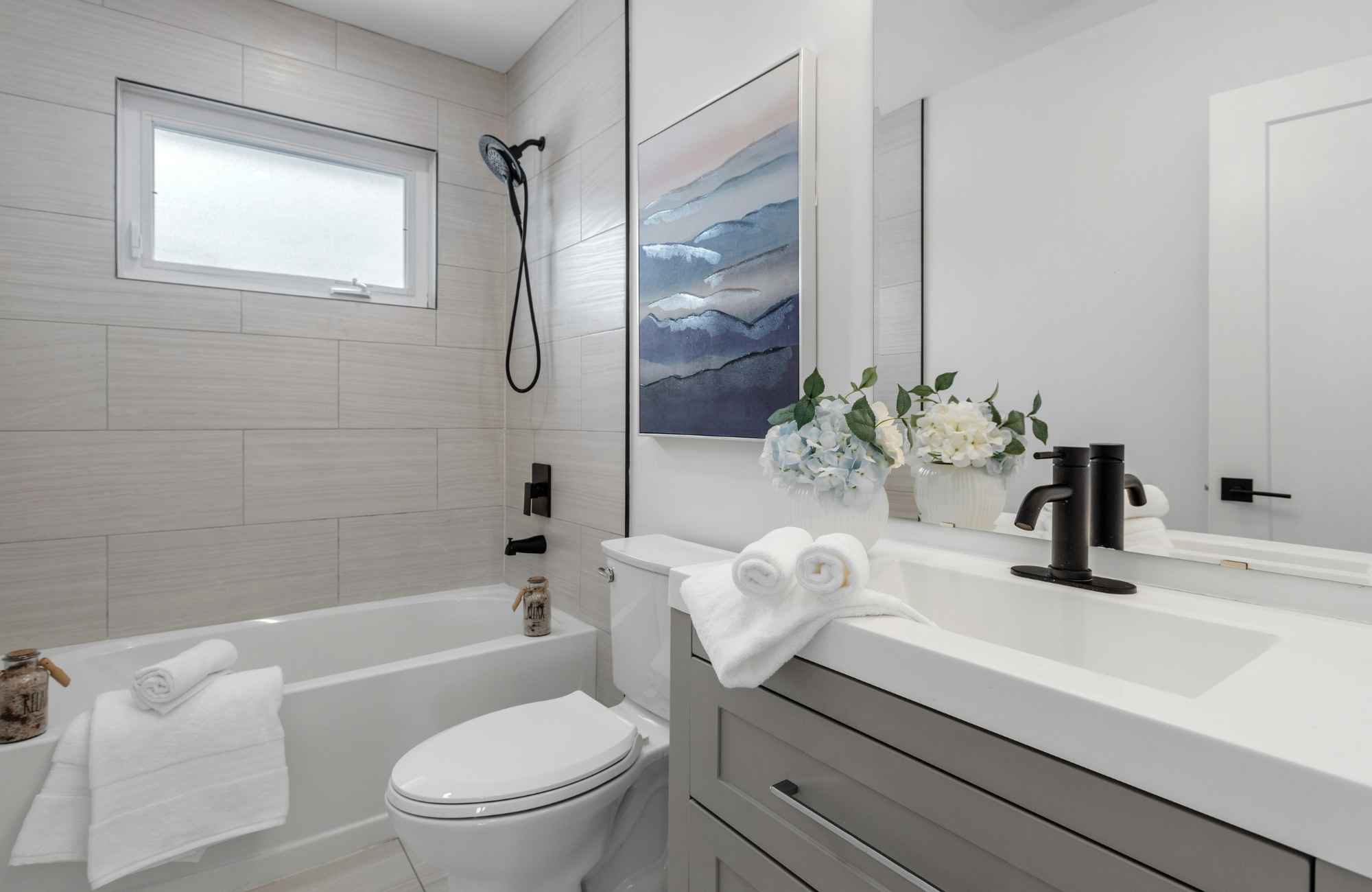mickler-and-co-design-studio-wilmington-nc-Bathroom staging with white towels and spa decor