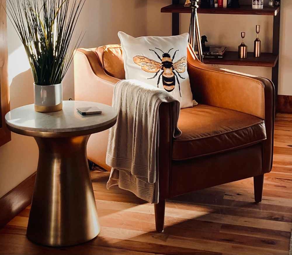 Leather Furniture: Enduring Luxury for Elevated Living 2 mickler-co-design-studio-wrightsville-beach-nc-luxury-leather-furniture-leather-chair-and-side-table-bee-pillow-sophisticated-rental-property-design